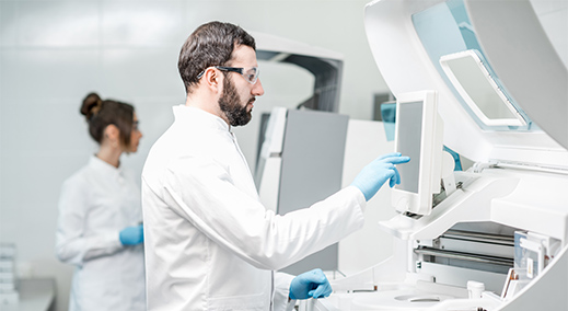 Medical and laboratory technology health lab employee in front of DATA MODUL panel pc